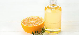 The oranges oil from orange on green studio background